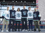 Seattle Kraken NHL hockey players Jordan Eberle, Chris Dreidger, Brandon Tanev, Jamie Oleksiak, Hadyn Fluery and Mark Giordano, from left, pose for a photo Wednesday, July 21, 2021, after being introduced during the Kraken's expansion draft event in Seattle. (AP Photo/Ted S.