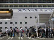 Passengers line up as they head toward the terminal where they will check in for their cruise to Alaska aboard the Serenade of the Seas at Terminal 91 in Seattle on July 19, 2021. (Ellen M.