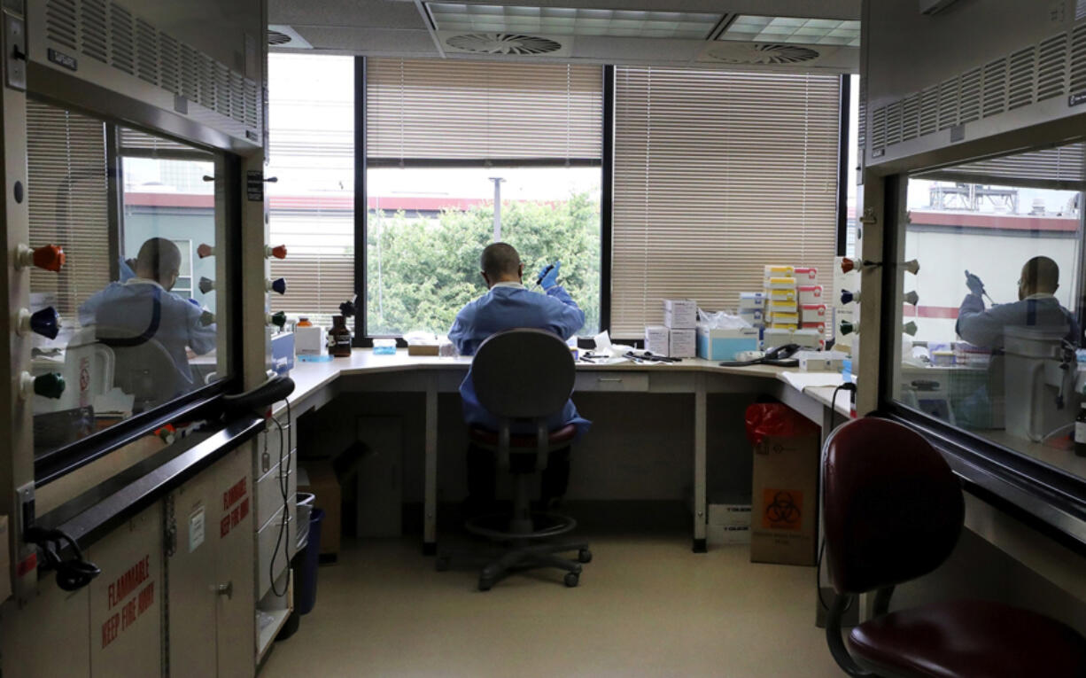 At the Washington State Patrol's toxicology lab in South Seattle, a forensic scientist prepares vials with cannabinoids (from marijuana) to be analyzed for various law-enforcement agencies on June 30. Meth contamination at the toxicology lab has put cases in jeopardy.