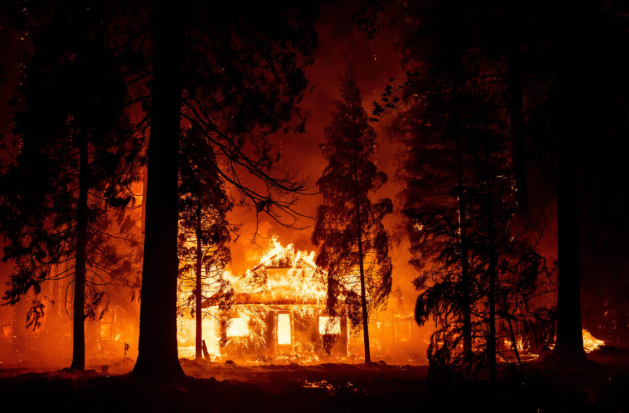 A home burns as flames from the Dixie fire tear through the Indian Falls neighborhood of unincorporated Plumas County, California, on Saturday, July 24, 2021.