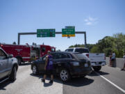 Stuck motorists survey the scene as they gather in the southbound Interstate 205 near the Mill Plain Boulevard exit on Friday afternoon, July 9, 2021.