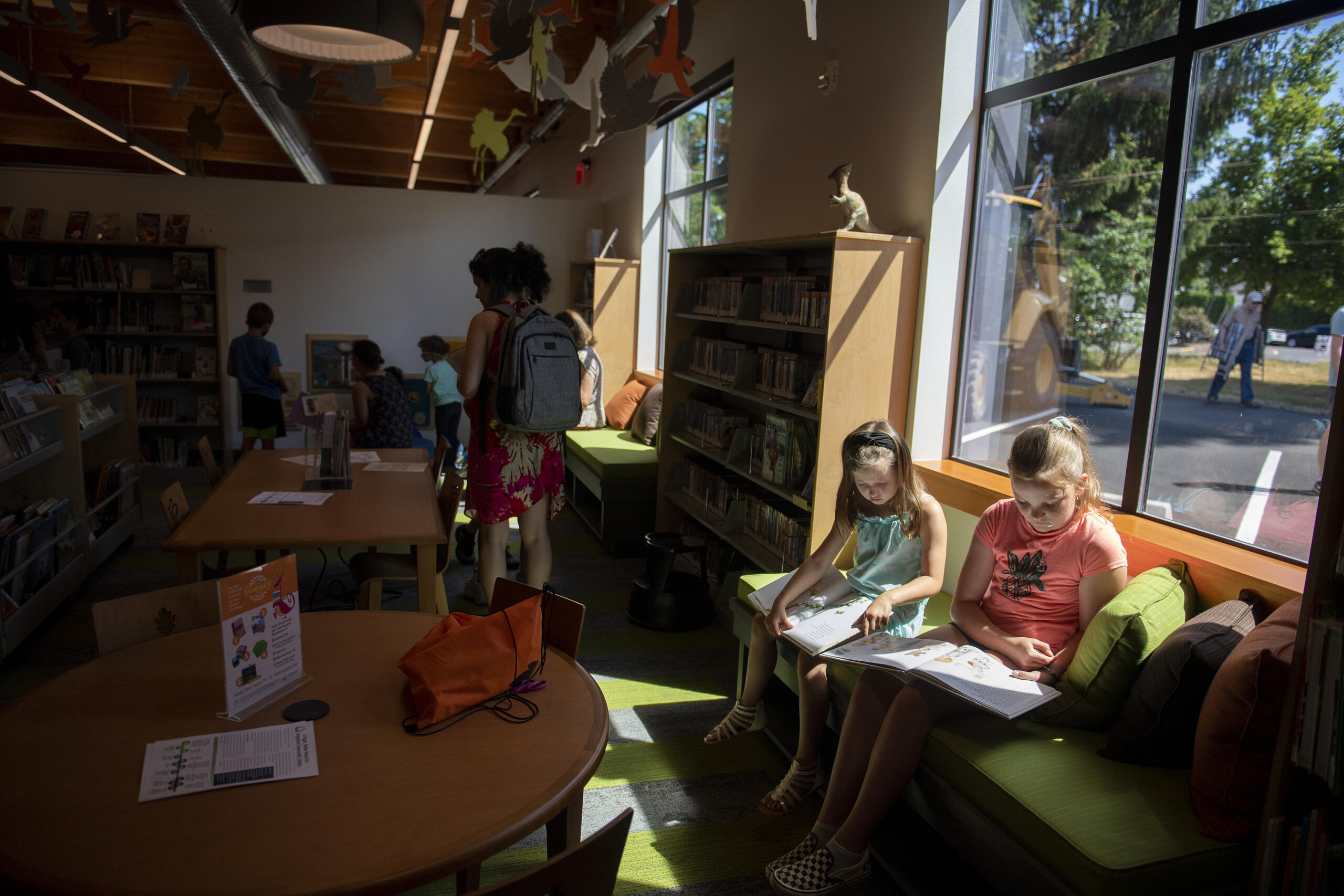 Cousins Lizzy Mire, 8, in blue, and Juel Natterstad, 10, cq, both of Ridgefield, enjoy a good book in the children's section at Ridgefield Community Library on Friday morning, July 9, 2021.