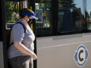 Vancouver resident Rachael Okerlund steps off a C-Tran bus wearing a face covering on Friday at the Vancouver Mall Transit Center. Face coverings remain a requirement on Vancouver public transit in accordance with CDC rules.