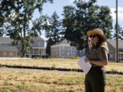 Joshua Hart/The Columbian 
 National Park Service curator Meagan Huff points toward the East Barracks on a July 17 walking tour discussing its history in the 1880s.