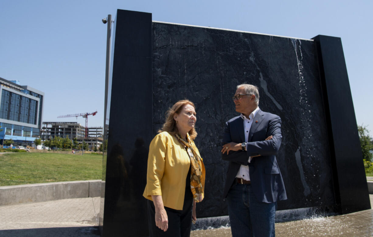 Vancouver Mayor Anne McEnerny-Ogle and Gov. Jay Inslee survey The Waterfront Vancouver while standing in front of an interactive sculpture that depicts the topography of the Columbia River on Tuesday. Inslee toured the waterfront with the mayor before meeting with local small-business owners.