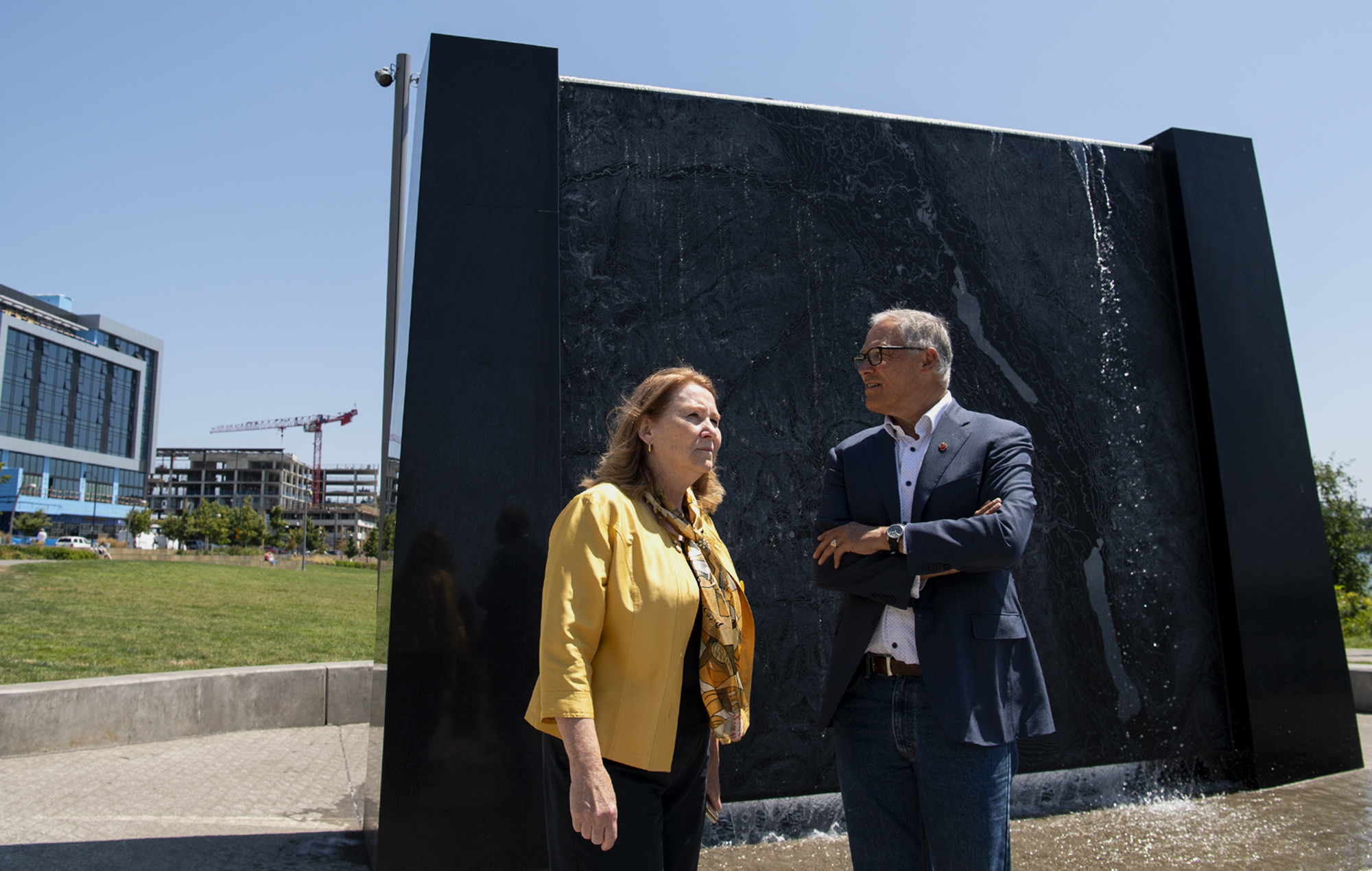 Vancouver mayor Anne McEnerny-Ogle and Washington governor Jay Inslee survey the Vancouver Waterfront while standing in front of an interactive sculpture that depicts the topography of the Columbia River on Tuesday, July 13, 2021, in Vancouver. Inslee toured the waterfront with Vancouver mayor Anne McEnerny-Ogle before meeting with local small business owners.