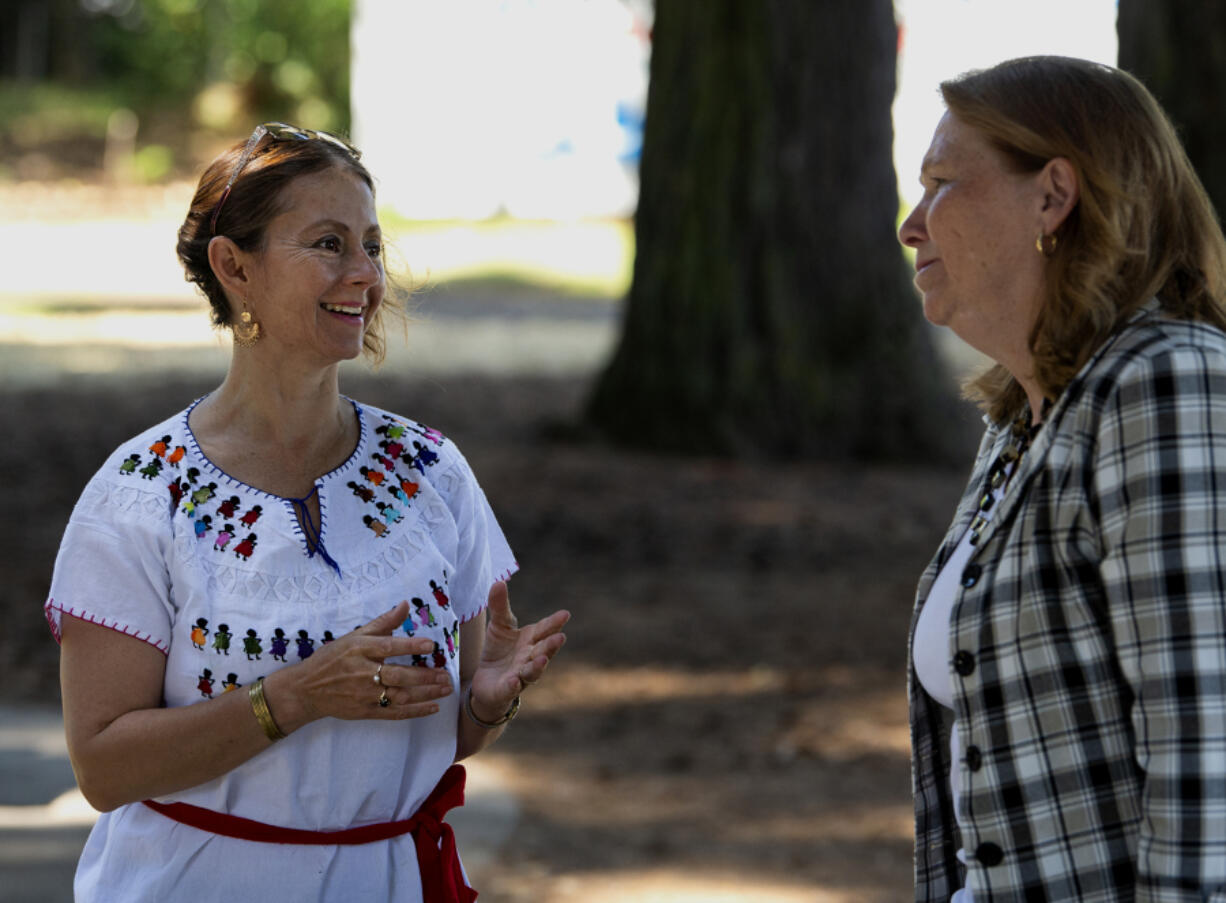 Anna Cruz speaks with Vancouver mayor Anne McEnerny-Ogle at the Espacio de Arte in El Parque on Saturday at Evergreen Park in Vancouver. Cruz, as part of Vancouver Ballet Folkorico and in partnership with Fourth Plain Forward and Artstra, hosts the "Art in the Park" event twice a month.