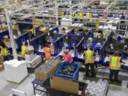 Workers assemble products and packaging on the manufacturing floor at Hawthorne Gardening Company in Vancouver in 2021.