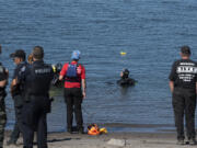 Divers search the waters off Frenchman's Bar Regional Park the morning after a man is believed to have drowned in the Columbia River on Sunday evening.