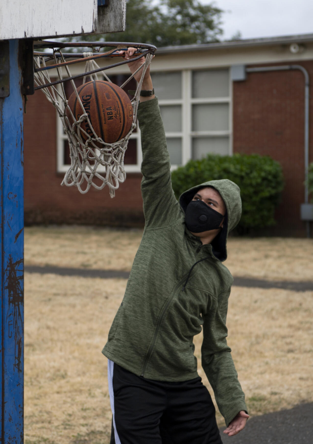 Roane Vanderley, 18, dunks a basketball at an Access to Recreation camp on Tuesday.