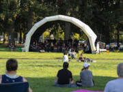 Visitors lounge in the grass to watch the Minidoka Swing Band on Thursday at a new park at Northeast 52nd Street and 137th Avenue in Vancouver's North Image neighborhood. Residents will be able to vote on the new park's name.