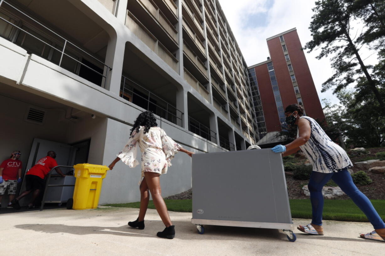 FILE - College students begin moving in for the fall semester at N.C. State University in Raleigh, N.C., Friday, July 31, 2020.  By the end of the U.S. head count last year, the Census Bureau lacked data for almost a fifth of the nation's occupied college dorms, nursing homes and prisons, requiring the statistical agency to make eleventh-hour calls to facilities in an effort to collect resident information or use a last-resort statistical technique to fill in the gaps.