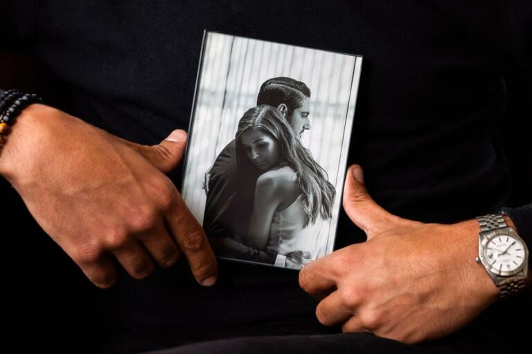 Abraham Dairi holds a photograph of him and his wife, Holly Deierling, while sitting at his home in Seattle's Montlake neighborhood on July 1, 2021. (Matt M.