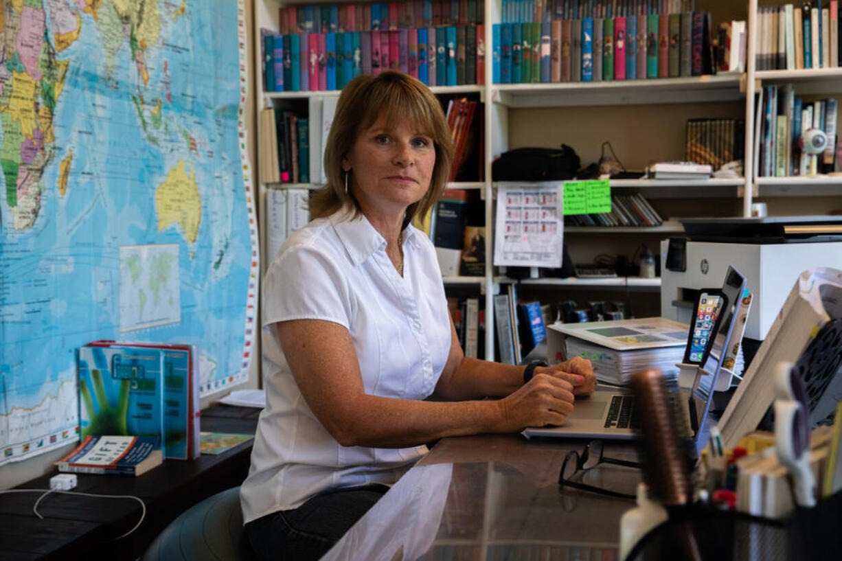 Shannon Beddo, a co-op school teacher based in Kingston, Wash., sits at her desk where she teaches remote classes on July 13, 2021. "Technology hates me," says Beddo, lamenting her internet service. "Sometimes when I'm doing video conference all I see is black boxes where my students faces should be. It's so important to be able to see them on the screen and I cannot." Beddo believes that everyone deserves quality broadband internet regardless of whether they live in urban areas or more rural parts of Washington state. (Matt M.