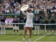 Australia's Ashleigh Barty poses with the trophy for the media after winning the women's singles final, defeating the Czech Republic's Karolina Pliskova on day twelve of the Wimbledon Tennis Championships in London, Saturday, July 10, 2021.