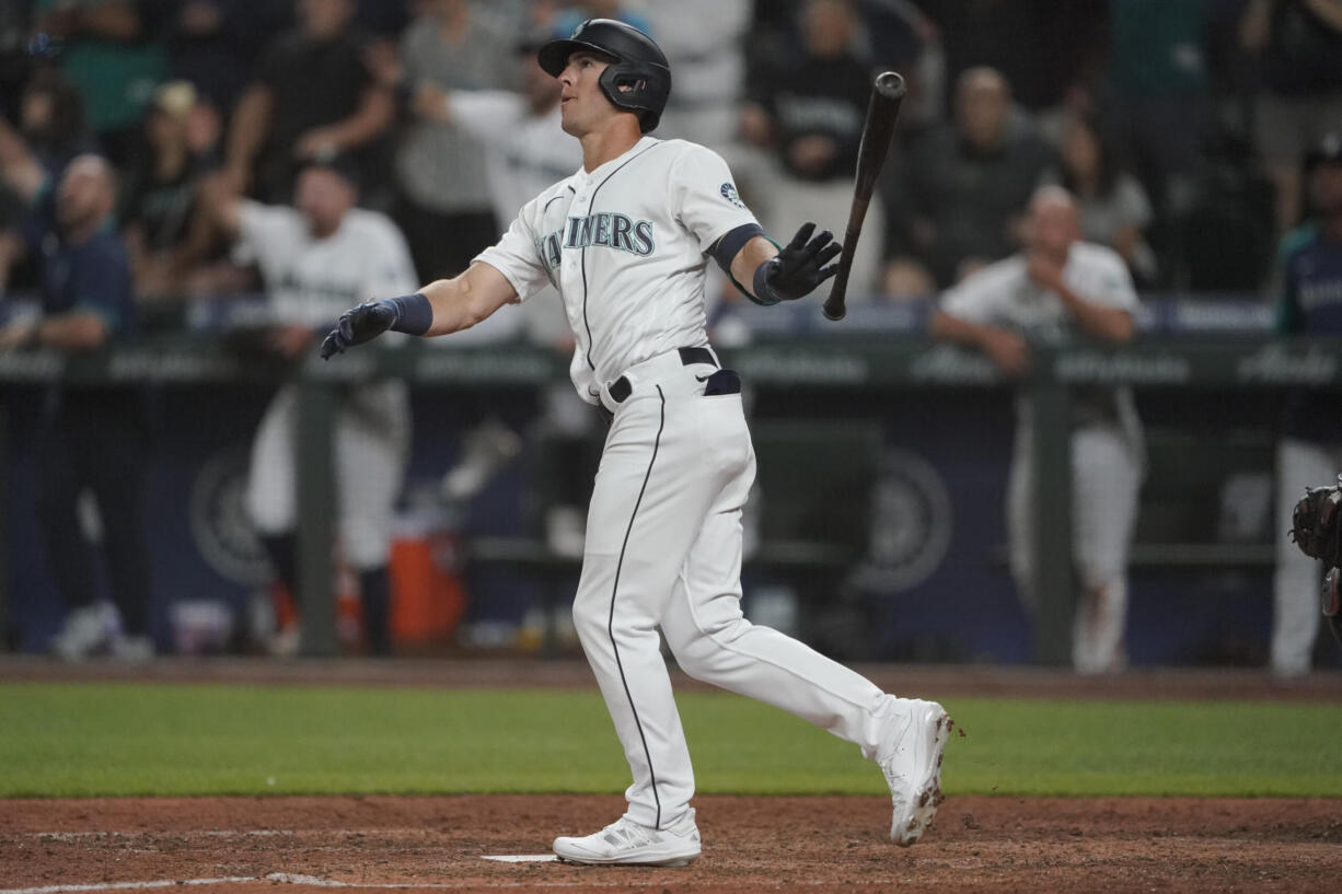 Seattle Mariners' Dylan Moore watches his grand slam during the eighth inning of a baseball game against the Houston Astros, Monday, July 26, 2021, in Seattle. (AP Photo/Ted S.