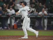 Seattle Mariners' Dylan Moore watches his grand slam during the eighth inning of a baseball game against the Houston Astros, Monday, July 26, 2021, in Seattle. (AP Photo/Ted S.