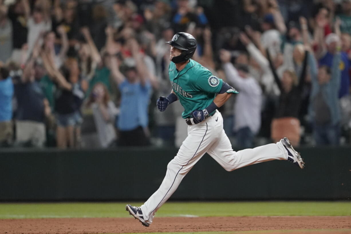 Seattle's Mitch Haniger rounds the bases after he hit a grand slam during the eighth inning Friday against the Los Angeles Angels.