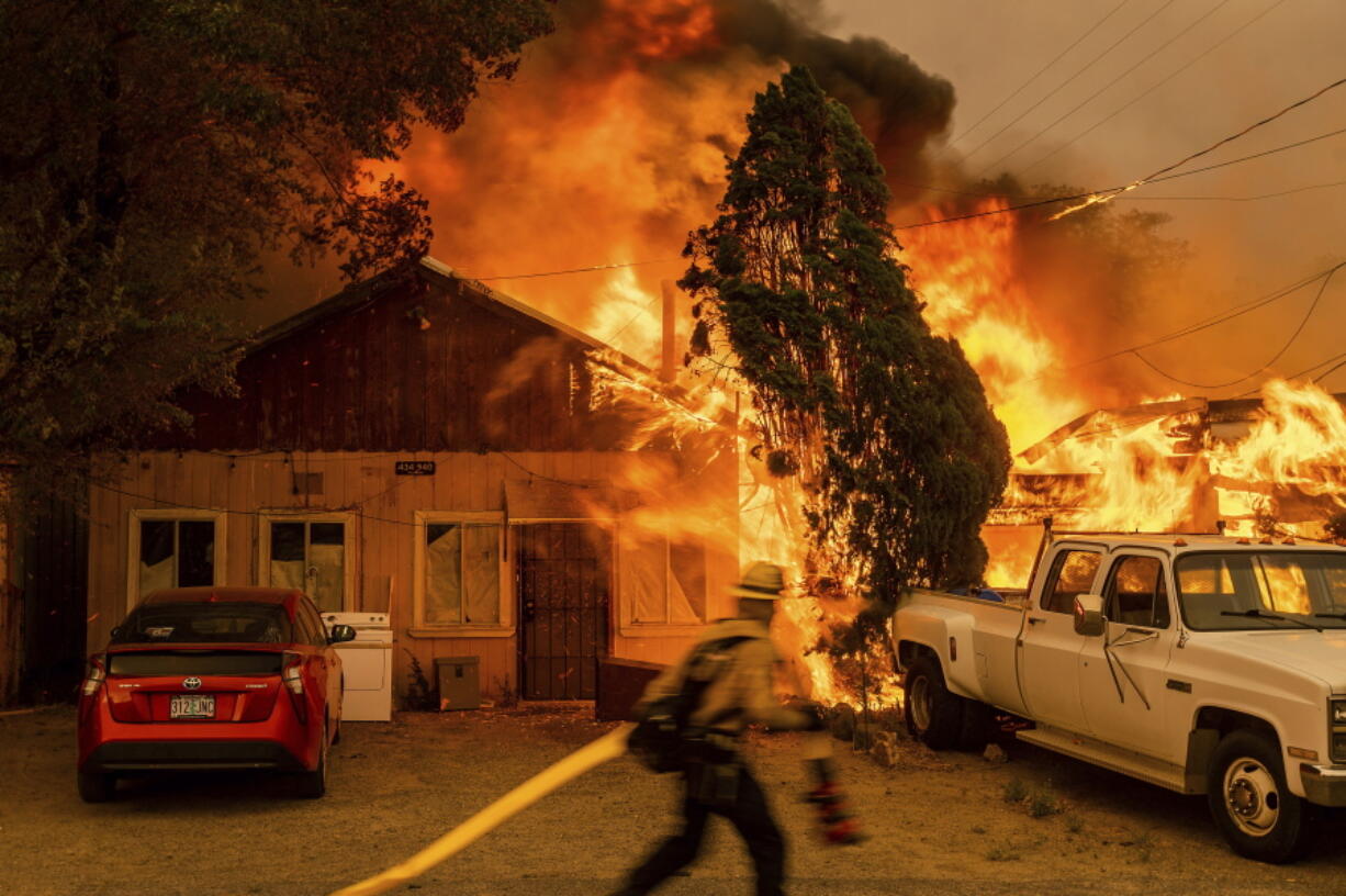 Fire consumes a home as the Sugar Fire, part of the Beckwourth Complex Fire, tears through Doyle, Calif., on Saturday, July 10, 2021. Pushed by heavy winds, the fire came out of the hills and destroyed multiple residences in central Doyle.