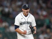 Seattle Mariners starting pitcher Chris Flexen yells after striking out Los Angeles Angels' Taylor Ward to end the top of the seventh inning of a baseball game Saturday, July 10, 2021, in Seattle.