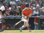 Houston Astros' Kyle Tucker watches his two-run home run, next to Seattle Mariners catcher Tom Murphy, during the eighth inning of a baseball game Wednesday, July 28, 2021, in Seattle.