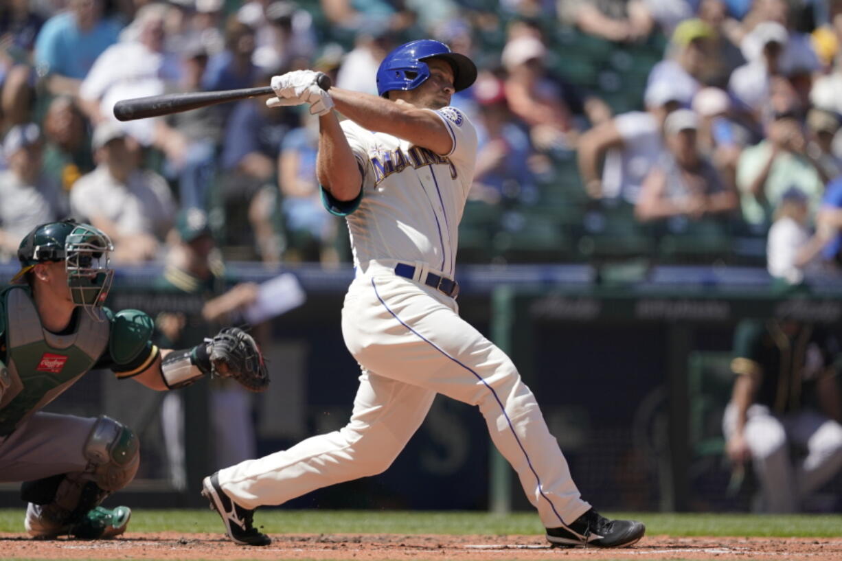 Seattle Mariners' Kyle Seager hits a two-RBI single against the Oakland Athletics during the third inning of a baseball game, Sunday, July 25, 2021, in Seattle. (AP Photo/Ted S.