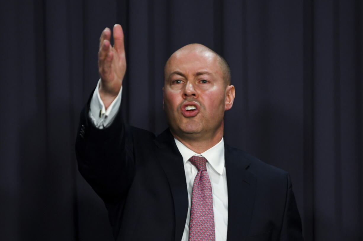 Australian Treasurer Josh Frydenberg speaks to the media during a press conference at Parliament House in Canberra, Wednesday, July 7, 2021. Frydenberg says Australia will keep its national interests ahead of economic interests in its troubled relationship with China after a White House official predicted long-term Sino-Australian tensions.