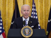 President Joe Biden announces from the East Room of the White House in Washington, Thursday, July 29, 2021, that millions of federal workers must show proof they've received a coronavirus vaccine or submit to regular testing and stringent social distancing, masking and travel restrictions in an order to combat the spread of the coronavirus. A new poll from The Associated Press-NORC Center for Public Affairs Research finds 6 in 10 Democrats say they're optimistic about their party's future. And Democrats nearly universally approve of the way President Joe Biden is handling his job.