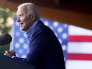 In this July 23, 2021 photo, President Joe Biden speaks at a campaign event for Virginia democratic gubernatorial candidate Terry McAuliffe at Lubber Run Park in Arlington, Va.  Biden will make his first visit to an agency of the U.S. intelligence community under sharply different circumstances than his predecessor, who often railed against the so-called "deep state" and openly questioned its conclusions. Biden is scheduled Tuesday afternoon to visit the Office of the Director of National Intelligence, which by law oversees the nation's 17 intelligence organizations.