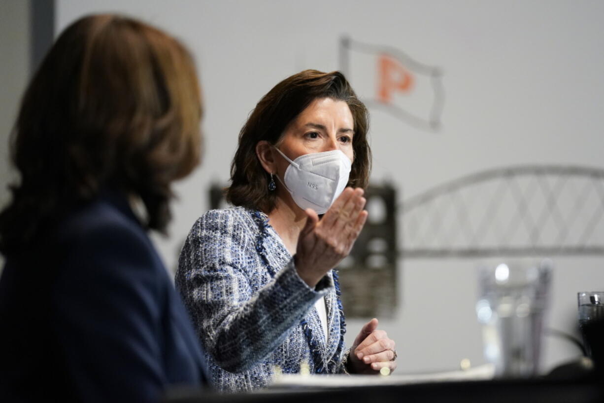 FILE - In this May 5, 2021, file photo, Vice President Kamala Harris, left, and Commerce Secretary Gina Raimondo participate in a roundtable with women-led small business owners in Providence, R.I. President Joe Biden's administration says it is making $3 billion in economic development grants available to communities. Raimondo tells The Associated Press her agency will begin accepting applications for the competitive grants, which officials hope will create hundreds of thousands of jobs.