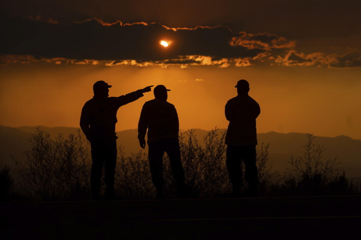 Cal Fire Capt. Robert Chesnick, left, speaks with firefighters Brent Hollinger, center, and Travis Burke while monitoring the Lava Fire burning in Weed, Calif., Thursday, July 1, 2021.