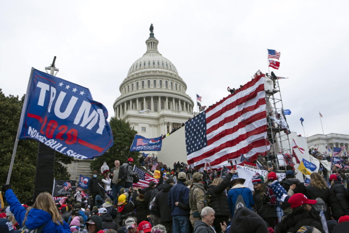 Rioters loyal to then-President Donald Trump outside of U.S. Capitol on  Jan. 6, 2021, in Washington. Even as the first of the more than 500 federal Capitol riot defendants have begun to plead guilty, scores of suspects remain unidentified, reflecting the massive scale of the Justice Department's investigation and the grueling work authorities still face to track everyone down.