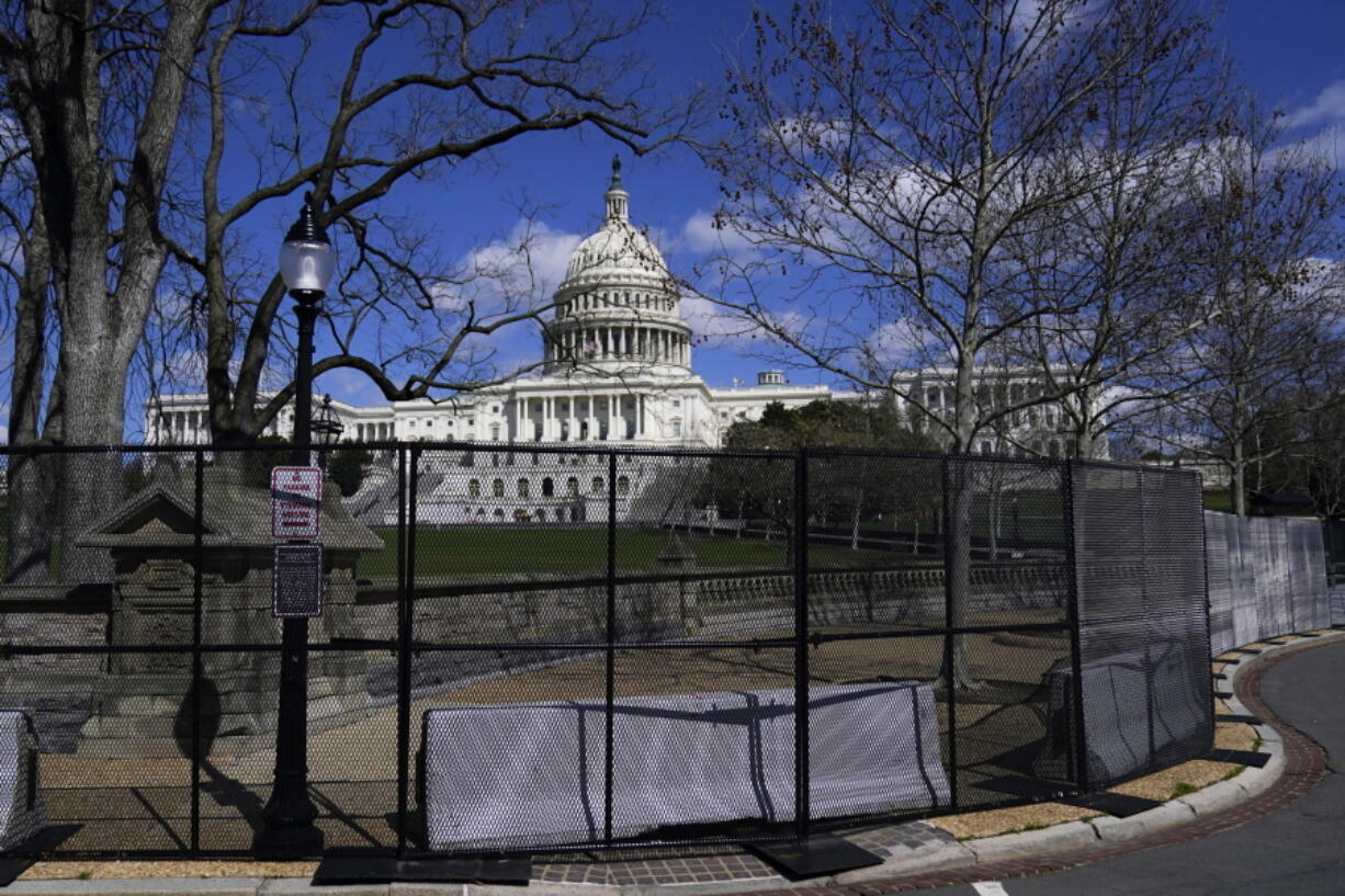 The U.S. Capitol is seen behind security fencing on April 2 in Washington. The fencing was installed after the  Jan. 6 insurrection.