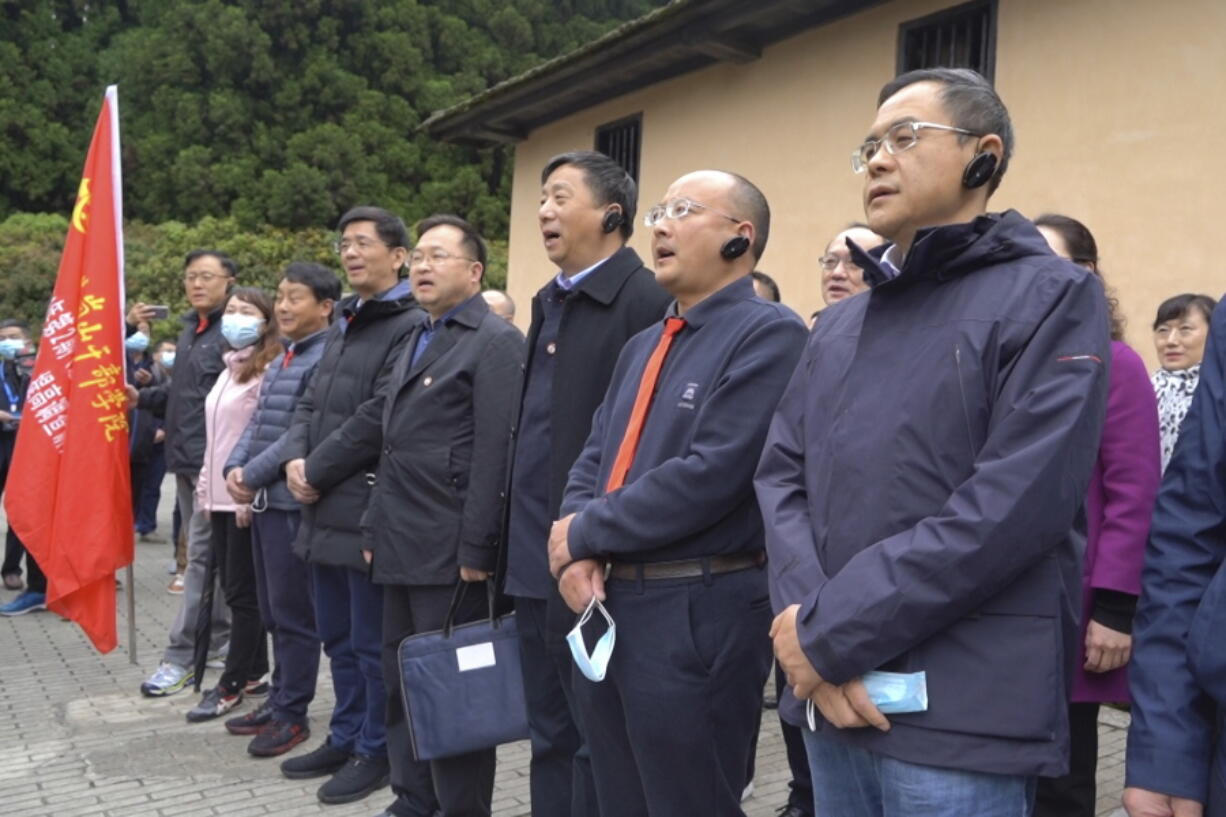 Students at the China Executive Leadership Academy recite a poem by revolutionary leader Mao Zedong in front of a wartime military outpost April 9 in Jinggangshan in southeastern China's Jiangxi Province. As China celebrates the 100th anniversary of the Community Party's 1921 founding, such trainings are part of efforts by President Xi Jinping's government to extend party control over a changing society.