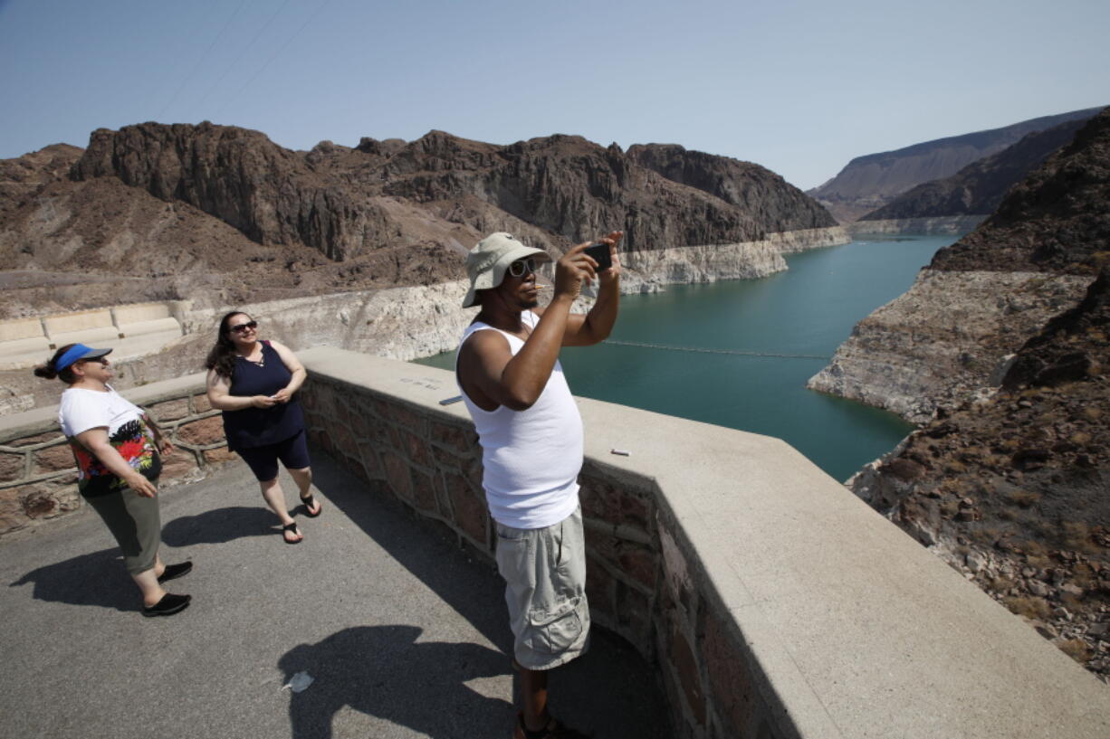 Eric Bonner of Lansing, Mich., visits the Arizona side of the Hoover Dam on Thursday with his mother-in-law Zina Ibragimova, left, and his sister-in-law Gamar Ibragimovai.