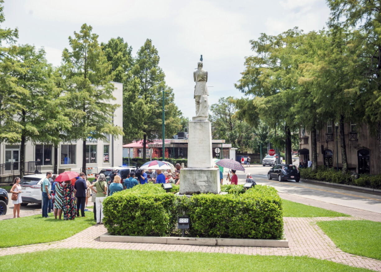 The statue of Confederate Gen. Alfred Mouton is seen outside city hall Friday, July 16, 2021 in Lafayette, La. The statue of a Confederate general will be moved from in front of a city hall in south Louisiana where it has stood for 99 years. News agencies report that the United Daughters of the Confederacy signed a settlement Friday agreeing to move the statue of Gen. Alfred Mouton or let the city of Lafayette do so. Noon Friday was the deadline for that group to turn over the names of Alfred Mouton Chapter members, with a trial scheduled July 26.