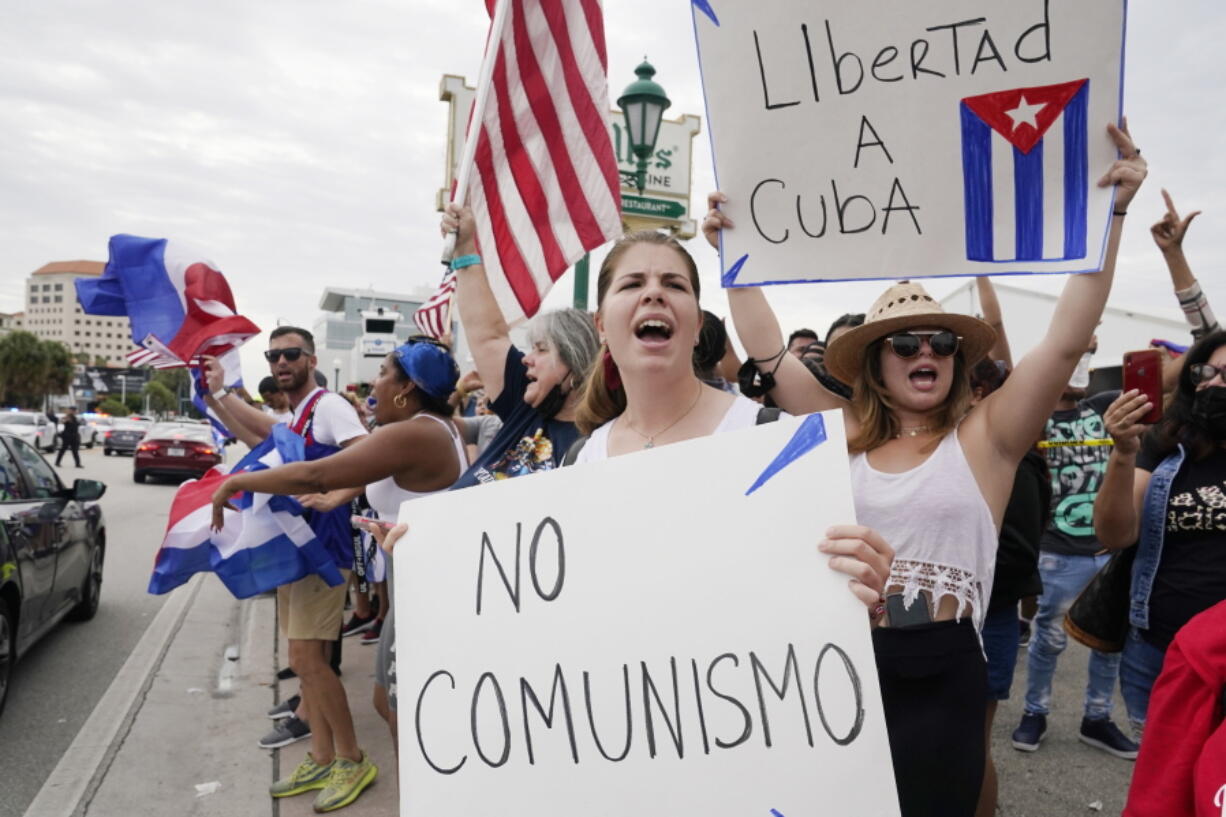 Cuban exiles rally at Versailles Restaurant in Miami's Little Havana neighborhood in support of protesters in Cuba, Monday, July 12, 2021, in Miami. Sunday's protests in Cuba marked some of the biggest displays of antigovernment sentiment in the tightly controlled country in years.