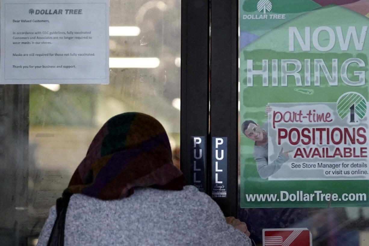 A shopper enters a retail store as a hiring sign shows in Buffalo Grove, Ill., Thursday, June 24, 2021.  America's employers added 850,000 jobs in June, well above the average of the previous three months and a sign that companies may be having an easier time finding enough workers to fill open jobs. (AP Photo/Nam Y.