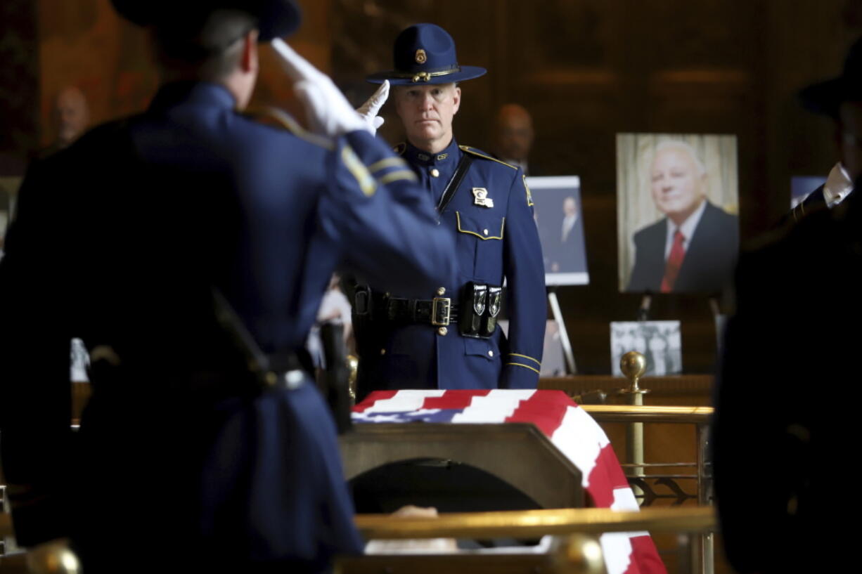 Members of the Louisiana State Police salute as former Louisiana Governor Edwin W. Edwards lies in state in Memorial Hall of the Louisiana State Capitol in Baton Rouge, La., Saturday, July 17, 2021. The colorful and controversial four-term governor died of a respiratory illness on Monday, July 12.