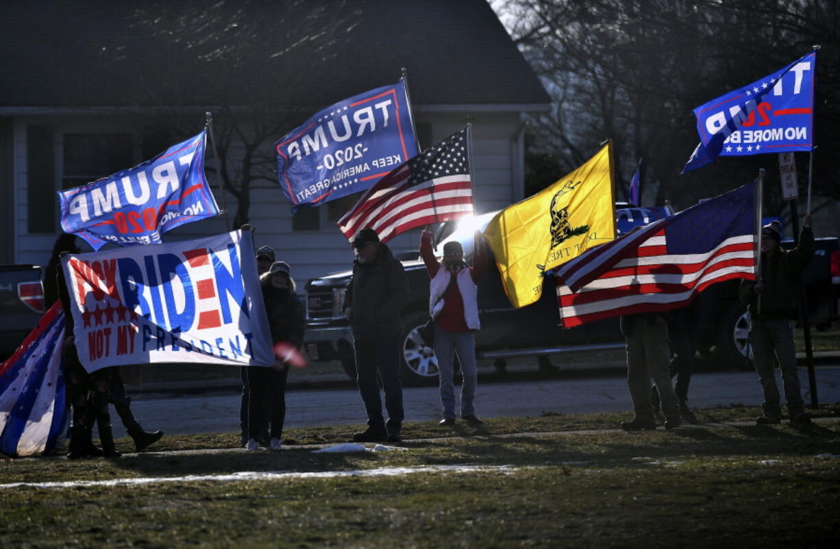 FILE - In this March 3, 2021, file photo, supporters of former President Donald Trump demonstrate outside as first lady Jill Biden and Education Secretary Miguel Cardona visit Fort LeBoeuf Middle School in Waterford, Pa. State Sen.