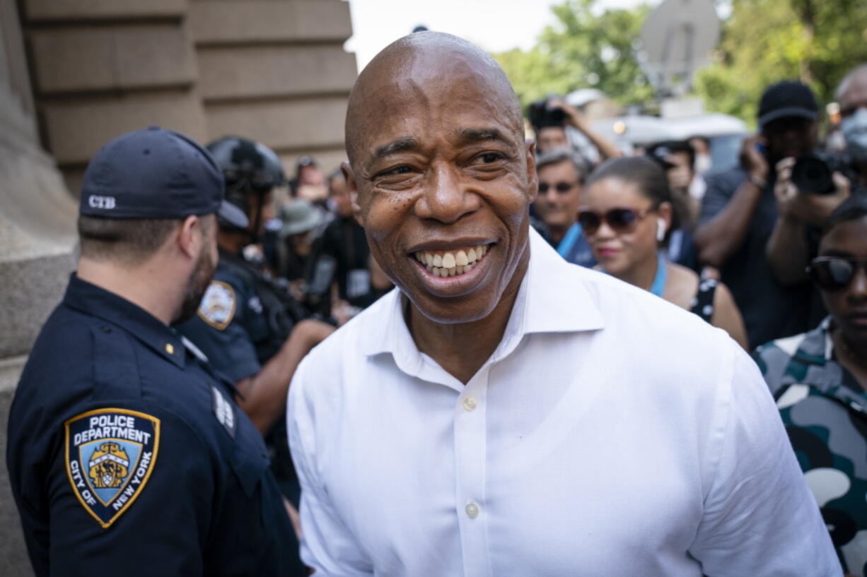 Brooklyn Borough President and a Democratic mayoral candidate Eric Adams greets NYPD officers as participants gather for a march through the financial district during a parade honoring essential workers for their efforts in getting New York City through the COVID-19 pandemic, Wednesday, July 7, 2021, in New York.  Adams bested a large Democratic field in New York's first major race to use ranked choice voting. Results from the latest tabulations showed him leading former city sanitation commissioner Kathryn Garcia.