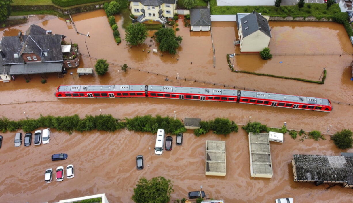 A regional train sits in the flood waters at the local station in Kordel, Germany, Thursday July 15, 2021 after it was flooded by the high waters of the Kyll river.