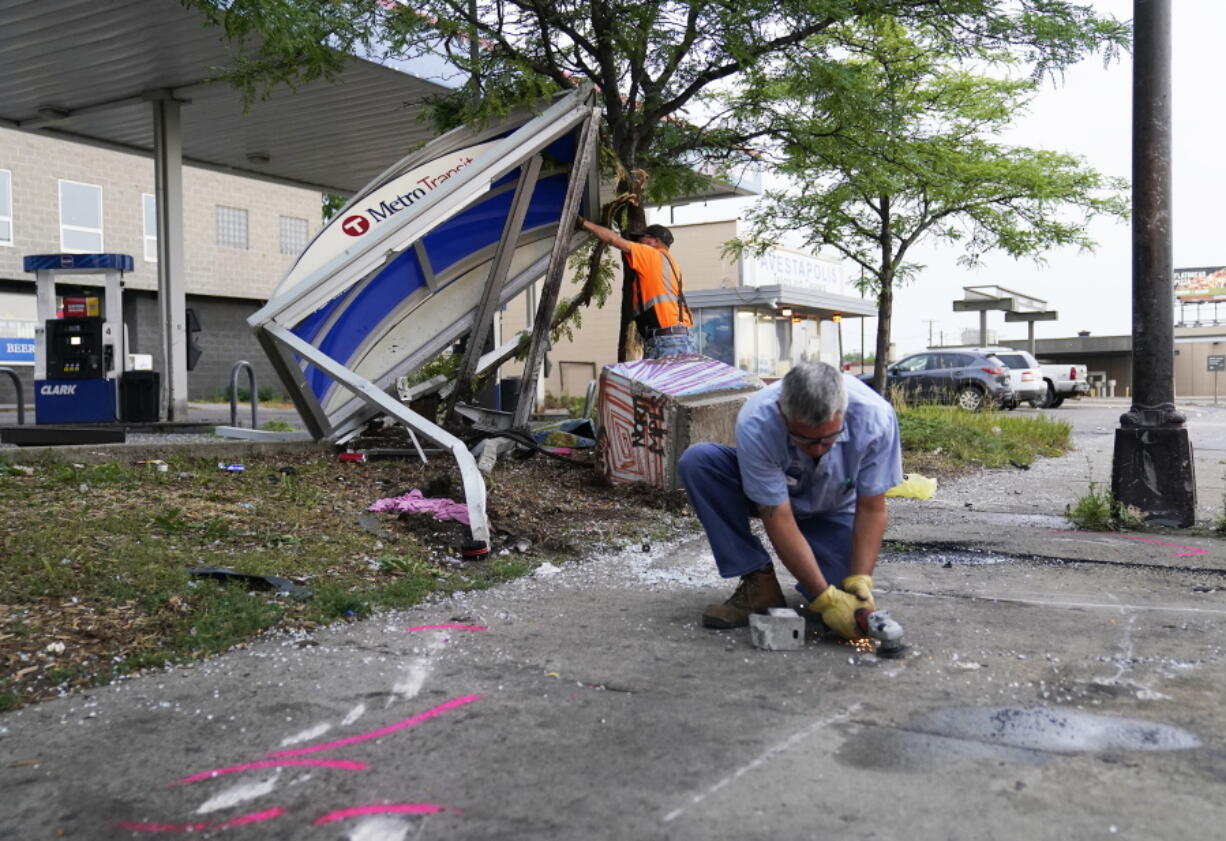 Investigators work the scene of a crash involving a Minneapolis police squad car Tuesday, July 6, 2021, in Minneapolis . A motorist died early Tuesday in a collision involving a Minneapolis police squad car that was pursuing a robbery suspect.