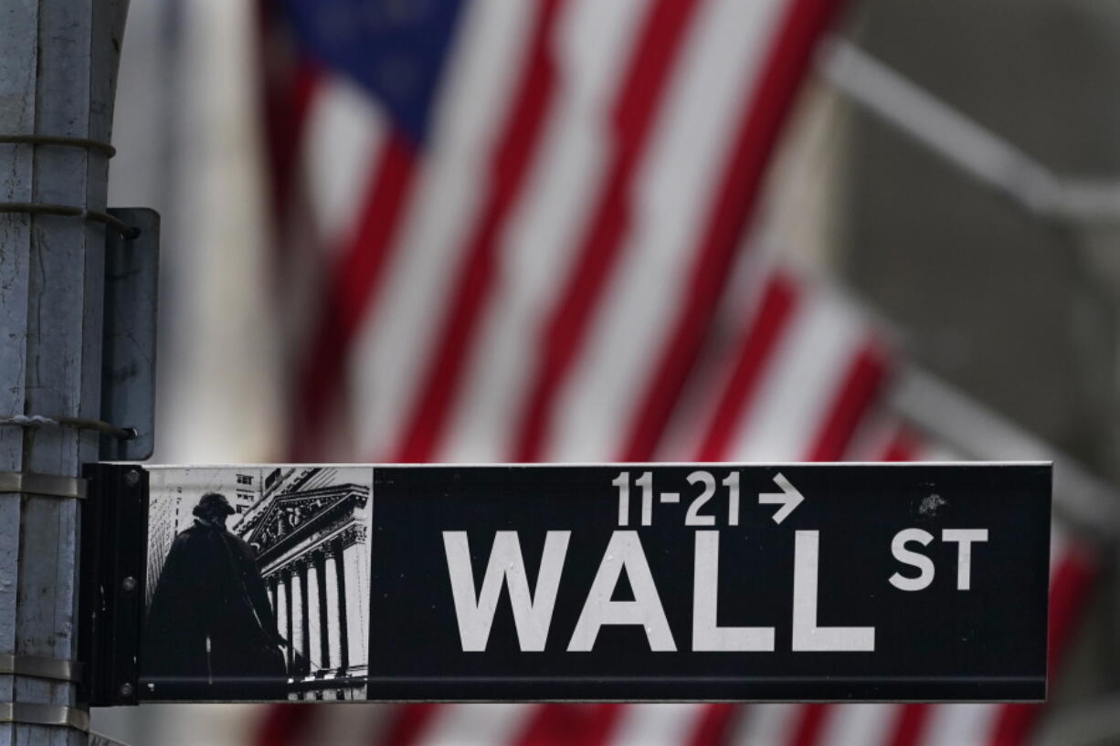 FILE - In this Nov. 23, 2020 file photo, a street sign is displayed at the New York Stock Exchange in New York. Stocks are off to a sluggish start on Wall Street as investors look over a surprise increase in claims for unemployment benefits and mixed news on corporate earnings. The S&P 500 was wavering between small gains and losses in the first few minutes of trading Thursday, July 22, 2021.