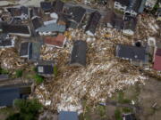 Debris of houses and trees surround houses in Schuld, Germany, Friday, July 16, 2021. Two days before the Ahr river went over the banks after strong rain falls causing severals deaths and hundreds of people missing.