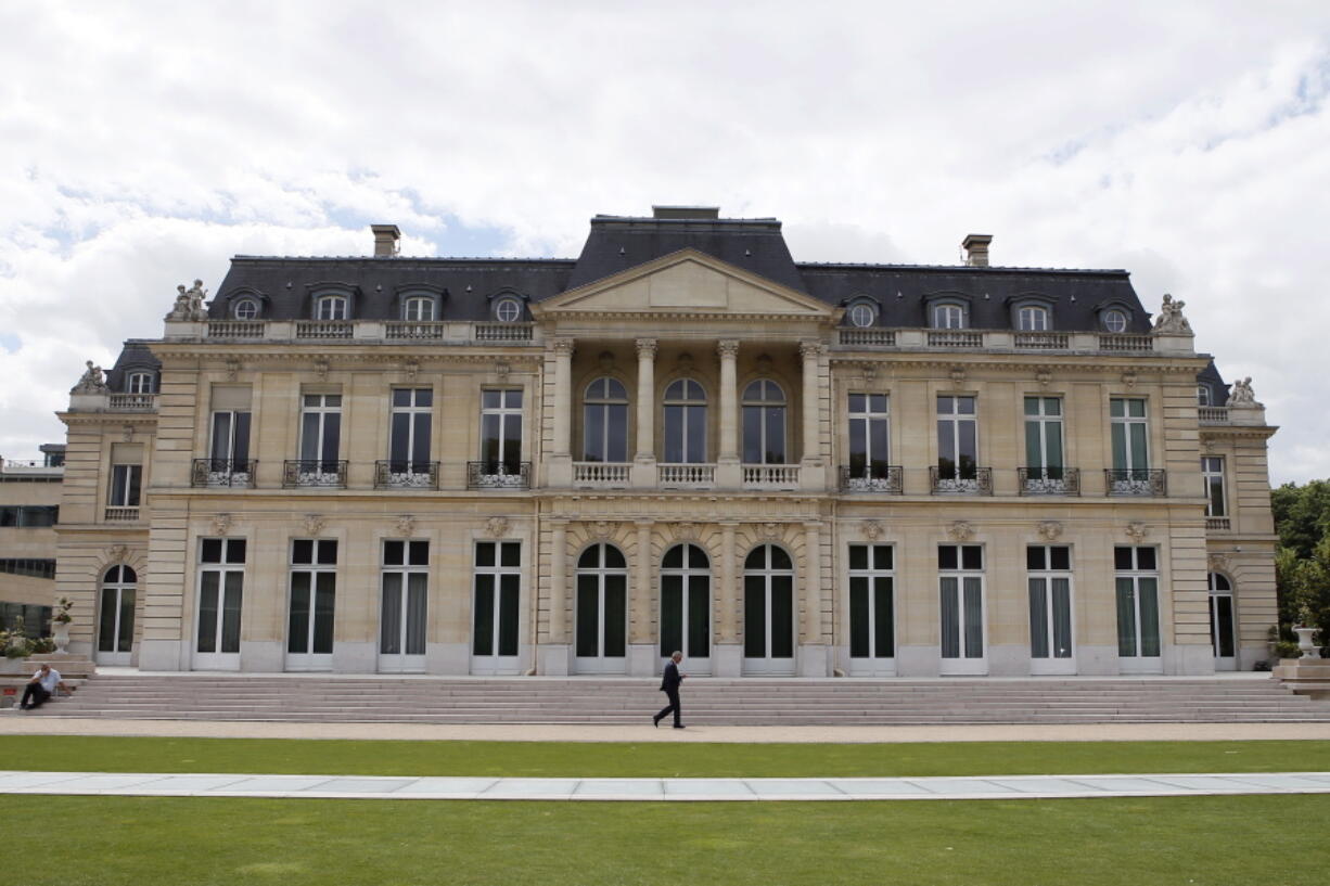 FILE - In this June 7, 2017 file photo, the Organisation for Economic Co-operation and Development (OECD) headquarters is pictured in Paris, France. Some 130 countries have backed a global minimum tax as part of a worldwide effort to keep multinational firms from dodging taxes by shifting their profits to countries with low rates.