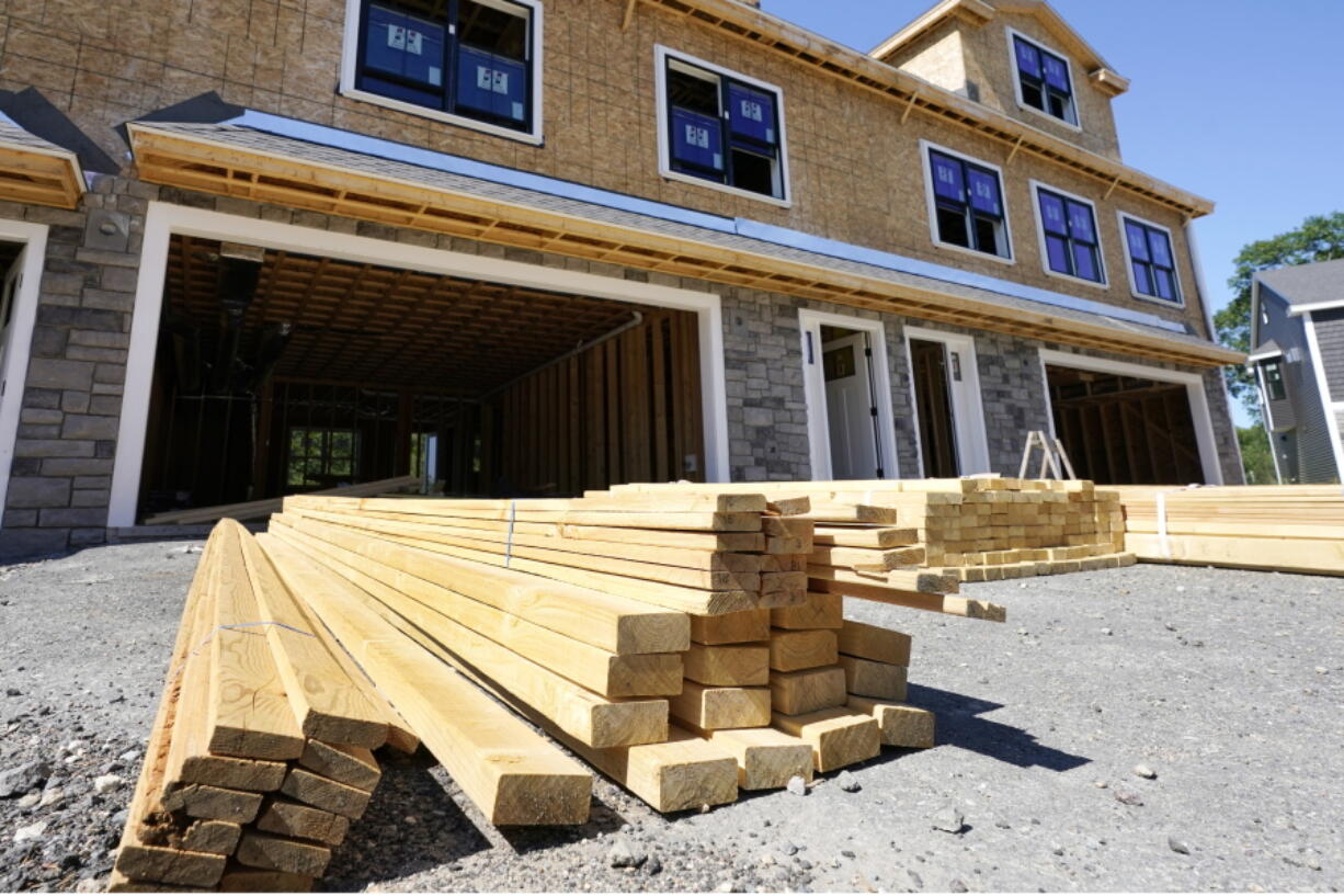 Lumber is piled at a housing construction site, Thursday, June 24, 2021, in Middleton, Mass.  Home construction in the U.S. rose a strong 6.3% in June, another big swing in what has been an up-and-down year so far. The rise in June put home construction at a seasonally adjusted annual rate of 1.64 million units, the Commerce Department reported Tuesday, July 20.