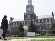 FILE - In this July 6, 2021, file photo with the Founders Library in the background, people walk along the Howard University campus in Washington. With the surprise twin hiring of two of the country's most prominent writers on race, Howard University is positioning itself as one of the primary centers of Black academic thought just as America struggles through a painful crossroads over historic racial injustice.