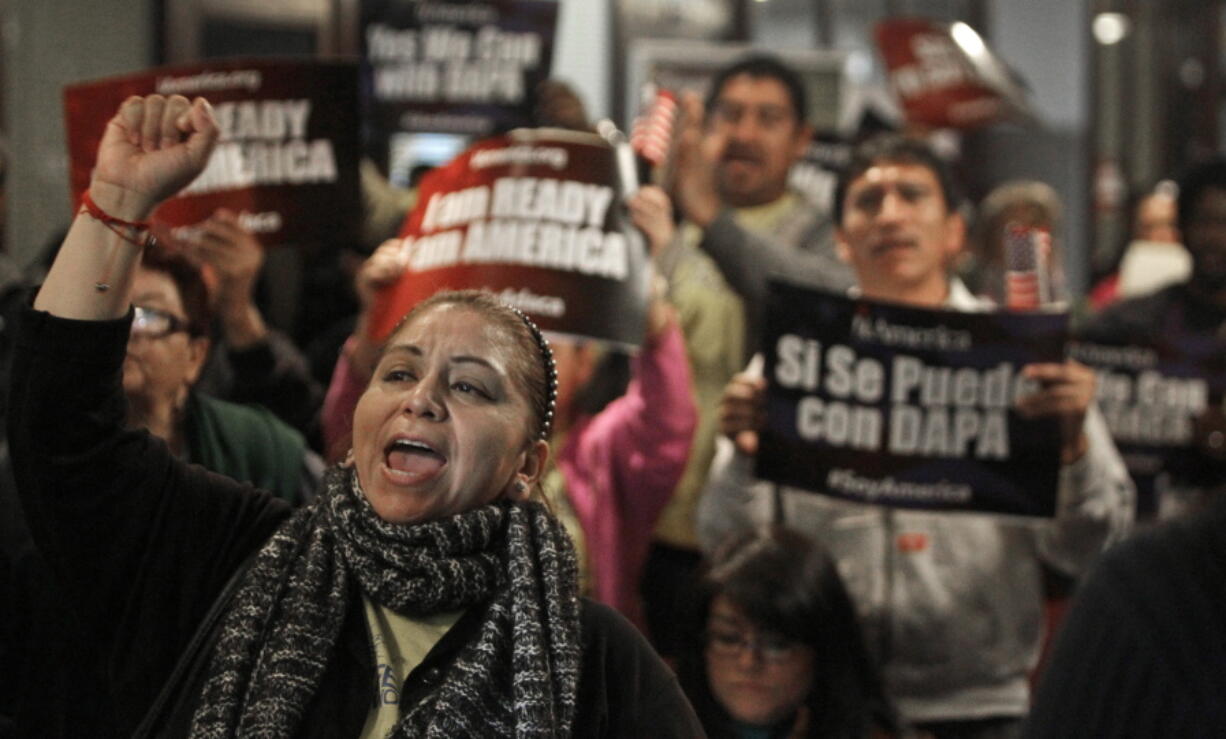 FILE - In this  Tuesday, Feb. 17, 2015 file photo, Mercedes Herrera and others chant during an event on DACA and DAPA Immigration Relief at the Houston International Trade Center in Houston. A federal judge in Texas on Friday, July 16, 2021 ordered an end to an Obama-era program that prevented the deportations of some immigrants brought into the United States as children, putting new pressure for action on President Joe Biden and Democrats who now control Congress.