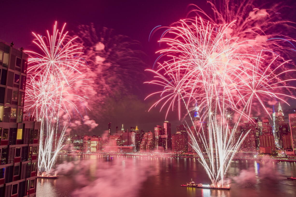 FILE - With the New York City skyline in the background fireworks explode during an Independence Day show over the East River in New York, in this Tuesday, July 4, 2017, file photo. After a year lost to the coronavirus, New York City's most well-known Fourth of July traditions are back. The traditional Macy's Fourth of July fireworks show will be back in full form with a display over the East River, with shells being shot from five barges in a televised, choregraphed spectacle.